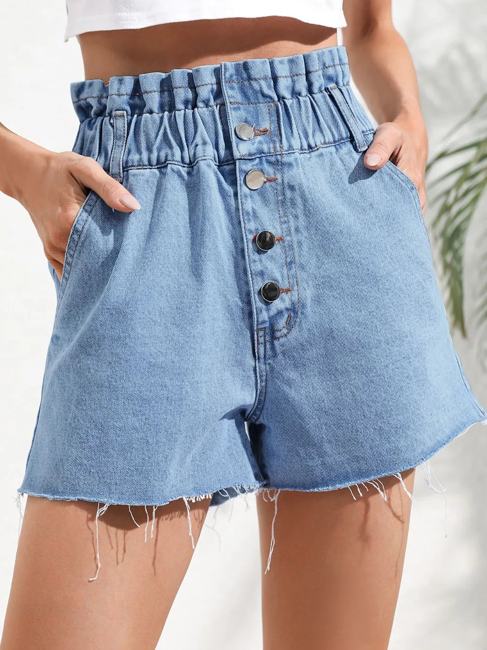Raw hem denim shorts women medium wash button pockets front view
